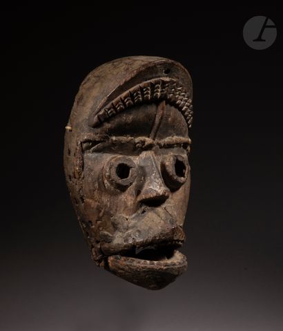 null An ancient and beautiful mask with an articulated jaw, with projected cylindrical...