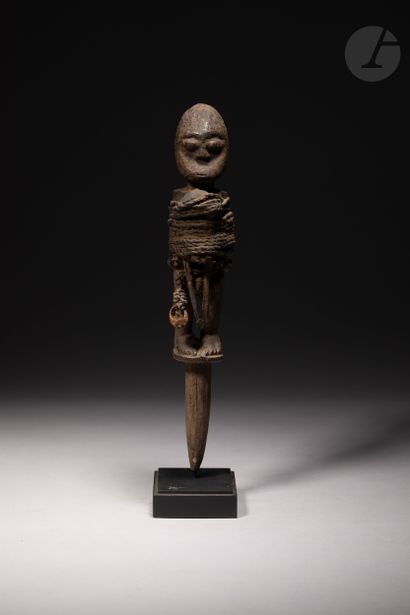 null 
Voodoo stake sculpture decorated with a character sculpted in foot, tied with...