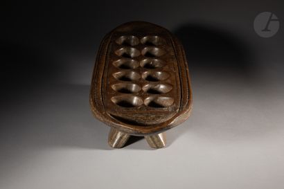 null Old game called awele or mankala with four splayed feet, engraved decorations,...