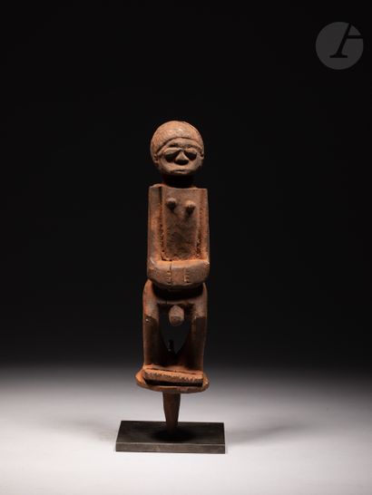 null A group of four voodoo stake statuettes, one of which is a male stake statuette...