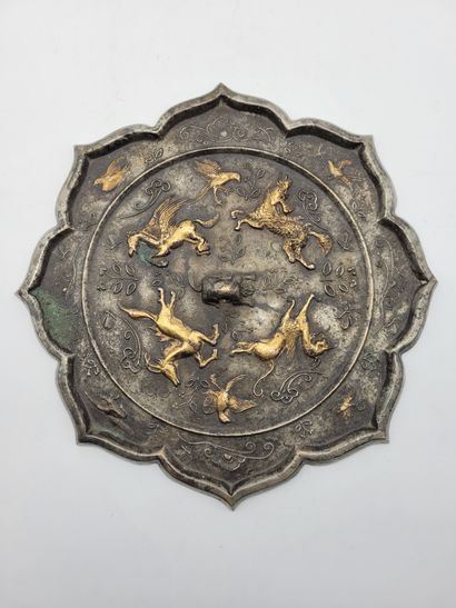 null Bronze mirror in the shape of a lotus flower with relief decoration of mythical...