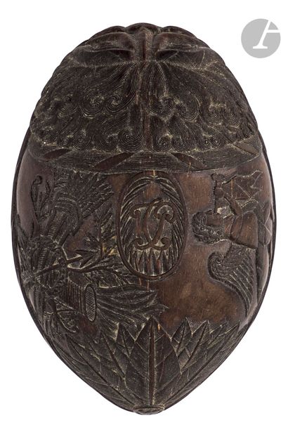 null Half coconut with beautiful patina carved in bas-relief of a leonine head and...