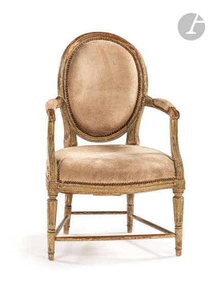 null Molded and painted beechwood armchair with a cabriolet medallion backrest, resting...