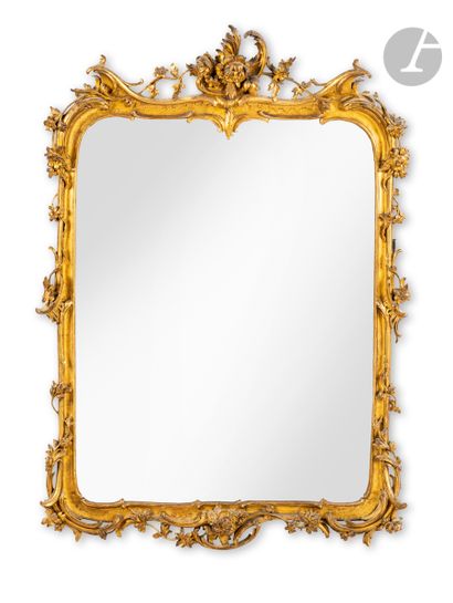  Miroir en bois doré à décor de feuillages et fleurs. Style italien du XVIIIe siècle....