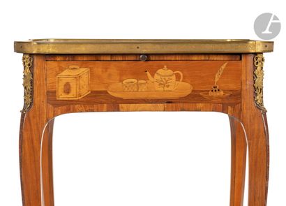 null Writing table in marquetry with musical instruments, the top resting on a belt...