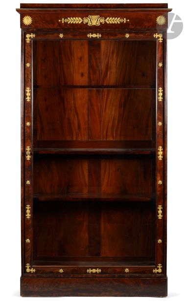 null *Flamed mahogany bookcase opening to a glass door, the molded cornice with lyre...