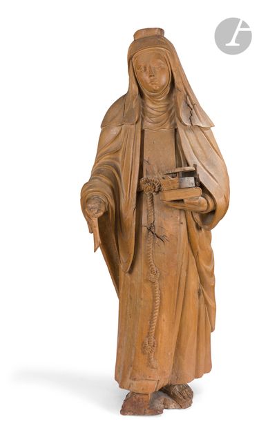  Sainte Elisabeth de Hongrie en noyer sculpté et patiné, dos plat et restes de polychromie....