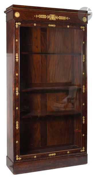 null *Flamed mahogany bookcase opening to a glass door, the molded cornice with lyre...