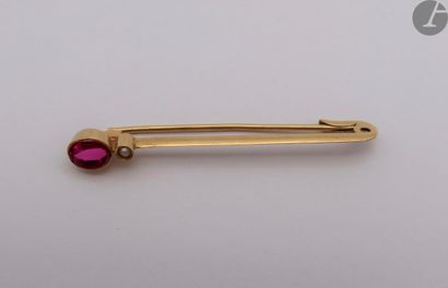  Epingle en or (18K) sertie d'un rubis ovale synthétique. Poids brut : 2,9 g 
Dans...