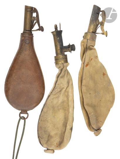  Three lead pears.{CR}Two in skin and one in leather, with brass measuring spout...