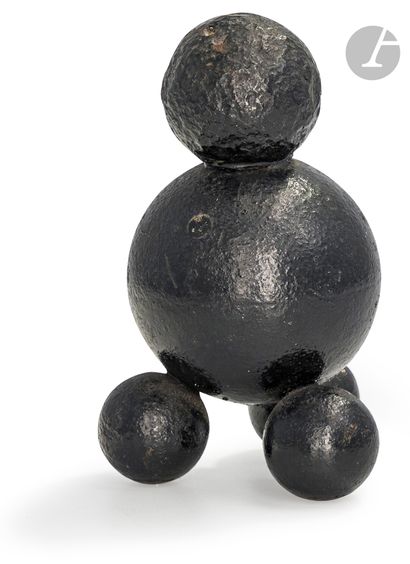 Stack of five cast iron cannonballs, one...