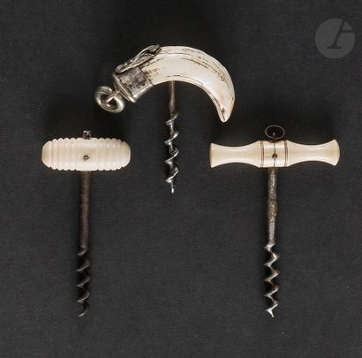 Three small simple corkscrews, the handles...