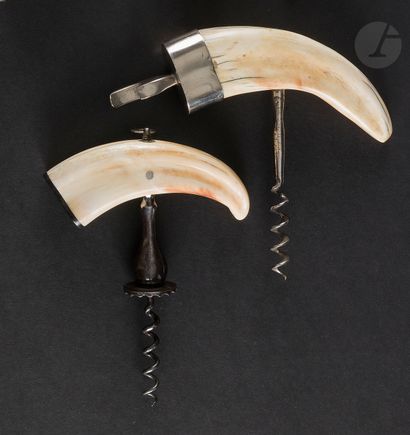 null Two simple corkscrews out of metal, the handles in tooth of warthog ringed at...