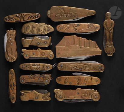 Sixteen stamped brass knives with cat, Titanic,...