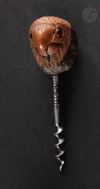 Simple corkscrew, the catch in a nut of carved corozo appearing a head of bird of...