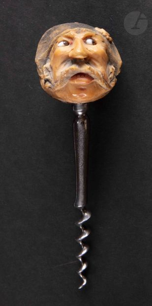 Simple corkscrew, the catch in a carved nut of corozo appearing a head of gendarme...
