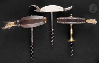 null Three corkscrews in iron or brass, one with a stopper, the handles in turned...