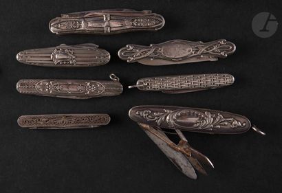  Seven pocket knives in silver metal embossed with scrolls, one is in spun metal....