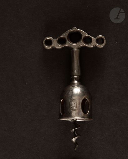  Simple corkscrew out of metal with openwork bell, the handle with five holes. Marked...