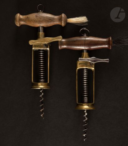  Two corkscrews with rack, the bronze cage and turned wooden handle. 
Marked " JM...