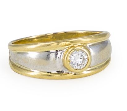 null Ring in two shades of 18K (750) gold, set with a round brilliant-cut diamond....