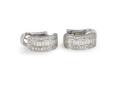 null Pair of 18K (750) white gold earrings, each set with 11 baguette diamonds between...
