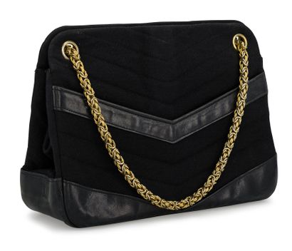 null CHANEL. Black herringbone jersey and leather bag, chain and gold metal trim....
