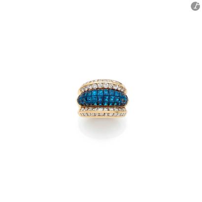 null Large 18K (750) gold ring, centered on a torus of calibrated sapphires between...