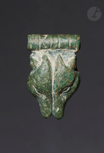 null Amulet showing a double profile of a wolf's head 
Surmounted by a tubular clasp.
Bronze.
Viking...