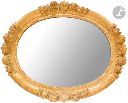 Gilded wood mirror of oval shape, decorated...