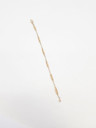 null Bracelet en or 18K (750), articulé de maillons filigranés scandés de perles....