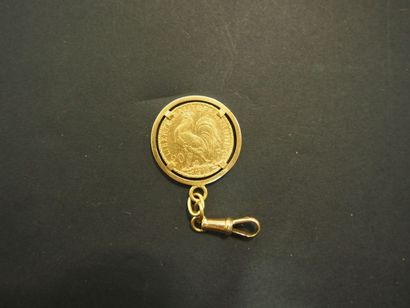 null 1 Pièce de 20 Francs en or type au coq (1913) dans une monture or jaune 18 K.
Poids:...