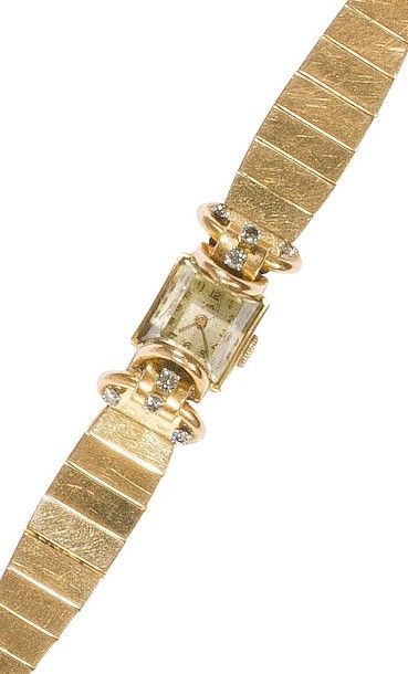 null Montre de dame en or jaune 18K (750‰), cadran carré, les anses formant des arceaux...