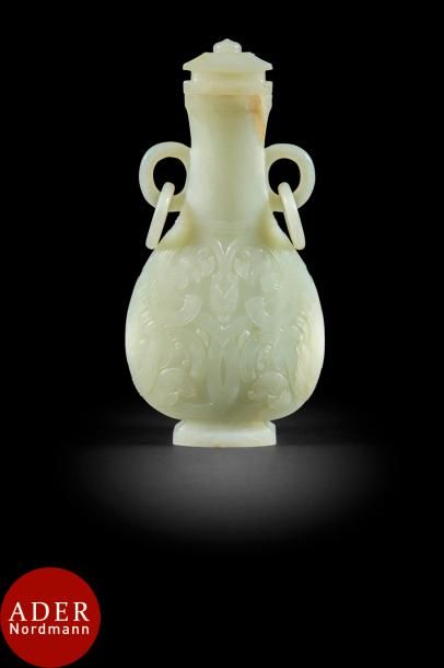 null CHINE - XIXe siècle
Vase couvert piriforme en néphrite à décor sculpté en léger...