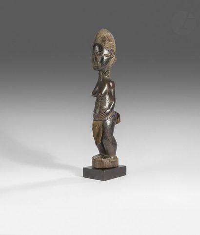 null Une jolie statuette waka sona féminine au visage et au corps scarifiés se tenant...