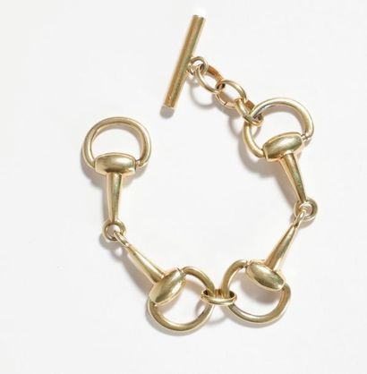 null Bracelet en métal doré, articulé de maillons formant des boucles asymétriques....