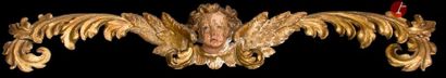 null Tête d’ange encadrée de rinceaux feuillagés en bois sculpté, polychromé et doré.
XVIIe...