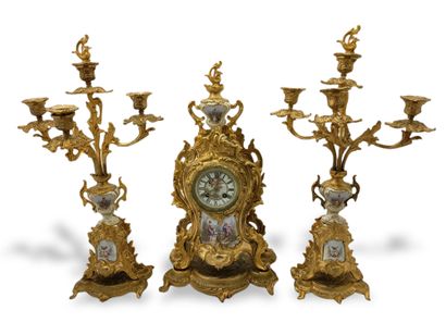 null A Louis XV style gilt bronze clock set in Rocaille decoration and porcelain...