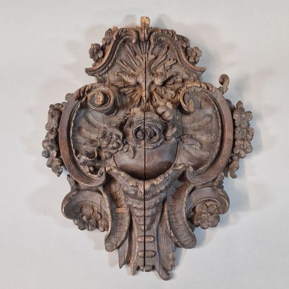 null Rocaille style, late 18th century, in carved and blackened wood, with centered...