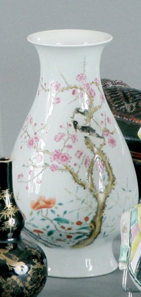 null Chine - Un vase en porcelaine polychrome à décor de fleurs signé en bas en 8...