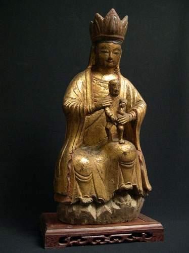 null T'SING (XXe siècle)
Boddhisattva assis tenant un enfant.
En bois sculpté polychrome...