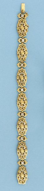 null Bracelet articulé en or jaune émaillé blanc serti de diamants. Vers 1900. P....