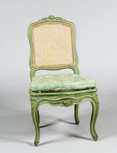 null Une chaise en bois sculpté de motifs de fleurs et relaquée vert. Dossier plat,...