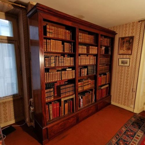 Null A mahogany veneered bookcase with three compartments and three drawers in t&hellip;