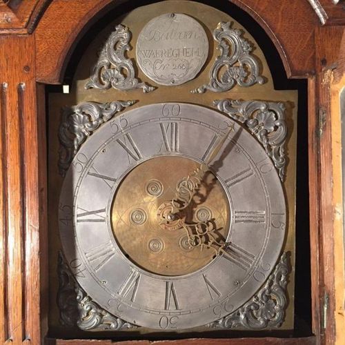 Null CLOCK. The case in natural wood opening by a door. The dial indicating the &hellip;