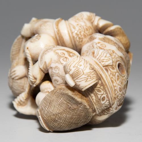 NETSUKE 网状物

日本，约1900年，象牙。署名梁根。描绘幸运之神惠比寿捆绑米袋的情景。一个跪着的男孩抱着他脚下的麻袋。高4厘米。