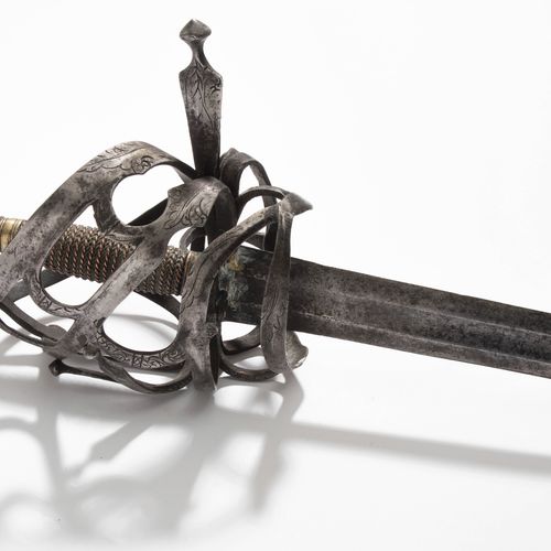 Korbschwert, Schiavona 篮子里的剑，Schiavona

意大利，约1700年。 紧贴篮子的刀柄由花纹带状的铁器制成，正面有一个无花果形的&hellip;