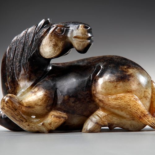 A BLACK AND CELADON JADE HORSE, 17TH CENTURY The squat horse has snuggled its le&hellip;