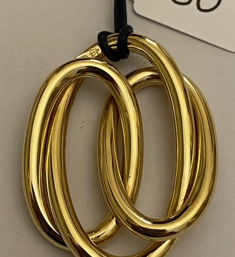Null String necklace, holding a large yellow gold pendant with interlaced motifs&hellip;