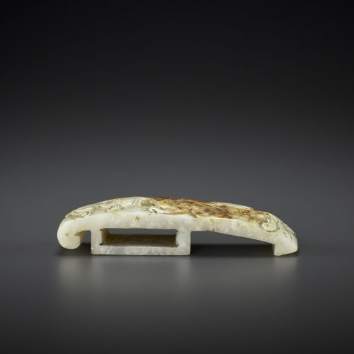 AN ARCHASITIC JADE SCABBARD SLIDE WITH DRAGON AMID CLOUDS, EARLY MING 明初云中龙纹玉石刀鞘&hellip;